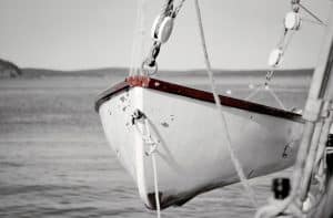 This black and white photograph with a color pop effect captures a life raft from the Margaret Todd, a renowned four-masted schooner based in Bar Harbor, Maine. The image focuses on the red hues of the raft's edges, contrasting vividly against the grayscale background of the serene waters and distant horizon. The Margaret Todd is celebrated for offering scenic tours and sunset cruises around Bar Harbor, allowing passengers to experience the majestic coastal landscapes of Maine. This photograph not only highlights the meticulous details of the life raft but also evokes a sense of preparedness and maritime heritage associated with the schooner.