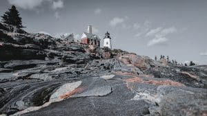 "Pemaquid Point Lighthouse Color Pop" showcases the iconic Maine lighthouse with a color pop effect, highlighting the rugged orange rocks against the grayscale sky and sea. A modern take on a coastal classic.