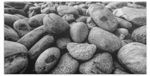 Rocks on the Beach" Towels Add a touch of coastal charm to your bathroom or beach day with the "Rocks on the Beach" towel. Featuring the stunning black-and-white photography of Blaine Stoner, this towel captures the natural beauty of smooth, weathered rocks scattered along the shoreline. Perfect for those who appreciate nature-inspired decor or a minimalist aesthetic.  Key Features:  Premium Quality Fabric: Made from 100% polyester, ensuring softness, absorbency, and durability for everyday use. Detailed, Fade-Resistant Print: The high-resolution image preserves the intricate textures and contrasts of the beach rocks, offering a timeless piece of art on a functional towel. Versatile Size Options: Available in multiple sizes, from hand towels to full beach towels, to suit your needs. Easy Care: Machine washable for effortless maintenance, keeping the towel looking sharp and fresh over time. Perfect for Any Bathroom:  Home Décor: Add a natural, earthy touch to your bathroom with this beautifully artistic towel. Gifting: A thoughtful gift for nature lovers, beach enthusiasts, or fans of Blaine Stoner's photography.