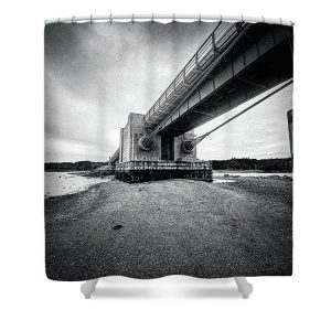 Add a touch of industrial elegance to your bathroom with our Under the Deer Isle Bridge Shower Curtain. This striking black and white photograph by Blaine Stoner captures the imposing structure of the Deer Isle Bridge from a unique, low-angle perspective, highlighting its massive support beams and intricate engineering. The dramatic tones and bold composition make this shower curtain a captivating addition to any space. Key Features: High-quality fabric: Made from 100% polyester, this shower curtain is durable, water-resistant, and designed to last. Crisp, fade-resistant print: The detailed black and white photography is printed with precision, ensuring that the textures and contrasts remain vibrant over time. Generous size: Measuring 71" x 74", it provides full coverage for standard showers and bathtubs. Easy installation: Comes with 12 reinforced hook holes, making it simple to hang with your favorite shower curtain hooks. Machine washable: Easy to care for, this shower curtain is machine washable, allowing for hassle-free maintenance. Perfect for any bathroom: Home decor: Bring a piece of architectural history into your home with this bold and artistic shower curtain. Gifting: This shower curtain makes a thoughtful gift for those who appreciate engineering, photography, and modern design. Transform your bathroom into a space of industrial beauty with the Under the Deer Isle Bridge Shower Curtain. Photography by Blaine Stoner.