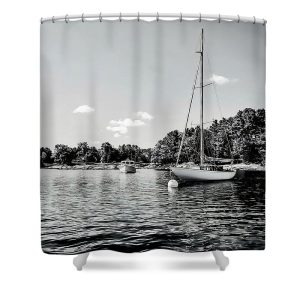 Add a touch of coastal charm to your bathroom with the Moored Boats shower curtain, featuring the serene photography of Blaine Stoner. This curtain showcases a peaceful scene of sailboats gently floating on calm waters, set against a backdrop of lush greenery and clear skies. The subtle black-and-white tones create a timeless and tranquil atmosphere, making it an ideal addition to any bathroom decor. Key Features: High-Quality Fabric: Made from durable, water-resistant polyester that drapes beautifully. Crisp, Fade-Resistant Print: The image is expertly printed to retain its sharpness and clarity, even after repeated washes. Standard Size: Fits most standard-sized showers and tubs. Easy Care: Machine washable for hassle-free maintenance.