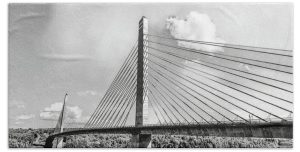 Capture the architectural elegance of the "Penobscot Narrows Bridge" towel. This towel features a striking black-and-white photograph of the Penobscot Narrows Bridge, an iconic cable-stayed bridge spanning the Penobscot River in Maine. The photograph highlights the bridge’s intricate design and engineering, with its towering pylon and sweeping cables creating a stunning visual effect. This towel is perfect for anyone who appreciates modern engineering marvels and wants to bring a piece of Maine's landscape into their home. Key Features: High-Quality Material: Crafted from soft, absorbent fabric that provides comfort and durability. Detailed, Fade-Resistant Print: The high-resolution print ensures that the image remains vibrant, even after multiple washes. Generous Size: Available in various sizes, offering ample coverage as a bath towel or a beach towel. Machine Washable: Easy to maintain; simply machine wash and tumble dry to keep the towel looking its best. Perfect for Any Home: Home Decor: Add a touch of architectural beauty to your bathroom or beach day with this unique towel. Gifting: Ideal for anyone who admires bridges, engineering, or Maine’s natural beauty. Bring a piece of Maine’s landscape into your home with the "Penobscot Narrows Bridge" towel. Photography by Blaine Stoner.