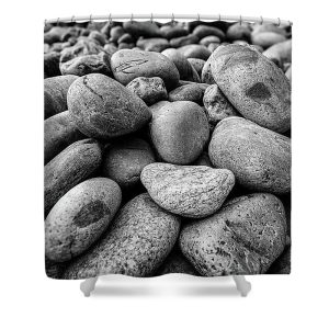 Transform your bathroom into a serene coastal retreat with our "Rocks on the Beach" Shower Curtain. This stunning photograph by Blaine Stoner captures the raw beauty of nature, showcasing a collection of smooth, weathered rocks along the shoreline. The intricate details and textures of the rocks are brought to life in monochrome, making this piece a perfect addition to any nature-inspired or minimalist decor. Key Features: High-Quality Fabric: Made from 100% polyester, this shower curtain is durable, water-resistant, and designed to last. Detailed, Fade-Resistant Print: The crisp, high-resolution photography ensures the natural textures and contrasts of the rocks remain vibrant over time. Generous Size: Measuring 71" x 74", it provides full coverage for standard showers and bathtubs. Easy Installation: Comes with 12 reinforced hook holes, making it simple to hang with your favorite shower curtain hooks. Machine Washable: Easy to care for, this shower curtain is machine washable, allowing for hassle-free maintenance. Perfect for Any Bathroom: Home Decor: Infuse your bathroom with the calming essence of the coast with this beautifully artistic shower curtain. Gifting: This shower curtain makes a thoughtful gift for nature lovers, photography enthusiasts, and those who appreciate coastal beauty. Bring a touch of the natural world into your bathroom with the "Rocks on the Beach" Shower Curtain. Photography by Blaine Stoner.