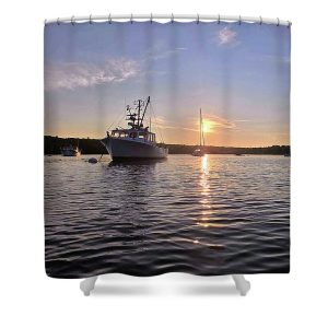 This evocative photograph captures the serene beauty of a sunset over Blue Hill Bay in Blue Hill, Maine. The tranquil waters of the bay reflect the warm evening light, illuminating a cluster of lobster boats and sailboats. The scenic backdrop of Blue Hill adds to the picturesque coastal landscape, epitomizing the peaceful maritime charm of Downeast Maine. The soft colors and calm atmosphere invite viewers to experience a moment of tranquility and appreciation for the natural beauty of the region. Bring the serene beauty of a coastal sunset into your bathroom with our Sunset on the Bay Shower Curtain, available through Fine Art America. This stunning photograph by Blaine Stoner captures the calm waters and moored boats basking in the warm glow of the setting sun. The vibrant colors and peaceful atmosphere make this shower curtain a perfect addition to any decor, creating a tranquil retreat right in your own home.