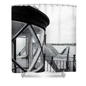 Step into a world of maritime history and scenic beauty with our Breakwater Shower Curtain. This striking photograph by Blaine Stoner captures the unique perspective from the lantern room of a lighthouse, looking down along the breakwater stretching into the bay. The intricate details of the lighthouse glass and the rugged breakwater below create a powerful image that brings a touch of coastal nostalgia to your bathroom. Key Features: High-quality fabric: Made from 100% polyester, this shower curtain is durable, water-resistant, and designed to last. Crisp, fade-resistant print: The detailed photography is printed with precision, ensuring that the natural textures and contrasts remain vibrant over time. Generous size: Measuring 71" x 74", it provides full coverage for standard showers and bathtubs. Easy installation: Comes with 12 reinforced hook holes, making it simple to hang with your favorite shower curtain hooks. Machine washable: Easy to care for, this shower curtain is machine washable, allowing for hassle-free maintenance. Perfect for any bathroom: Home decor: Infuse your bathroom with the rugged charm of the Maine coast with this unique and artistic shower curtain. Gifting: This shower curtain makes a thoughtful gift for those who appreciate lighthouses, photography, and maritime history. Transform your bathroom into a seaside sanctuary with the Breakwater Shower Curtain. Photography by Blaine Stoner.