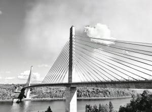 The Penobscot Narrows Bridge, a striking cable-stayed bridge, spans the Penobscot River in Maine. It connects the towns of Prospect and Verona Island, offering not only vital transportation infrastructure but also breathtaking views of the river and surrounding landscapes. Completed in 2006, this bridge replaced the aging Waldo-Hancock Bridge and features a unique observatory located in one of its towers, providing panoramic views of the area. This black and white photograph captures the geometric elegance of the bridge’s design, emphasizing the lines and symmetry of its cables against the tranquil backdrop of the river and sky.