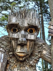 Photograph of a wooden troll from the "Guardians of the Seeds" exhibit at Boothbay Botanical Gardens, captured by Blaine Stoner.