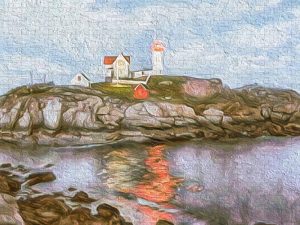 Painterly photograph of Nubble Lighthouse at dusk, with its light reflecting on the water, captured by Blaine Stoner.