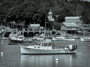 Lobster boats anchored in Bass Harbor, Maine—timeless vessels beneath the quiet charm of a coastal village.