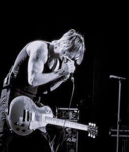 John Rzeznik plays harmonica with heartfelt intensity during the Goo Goo Dolls’ Bangor Waterfront show, August 5, 2025.