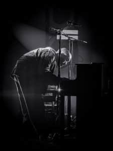 Black and white photograph of Matt playing piano live with Unspoken at Ellsworth Assembly of God in Ellsworth, Maine.